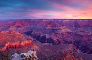  A person is dwarfed by the enormity of the Grand Canyon in Arizona